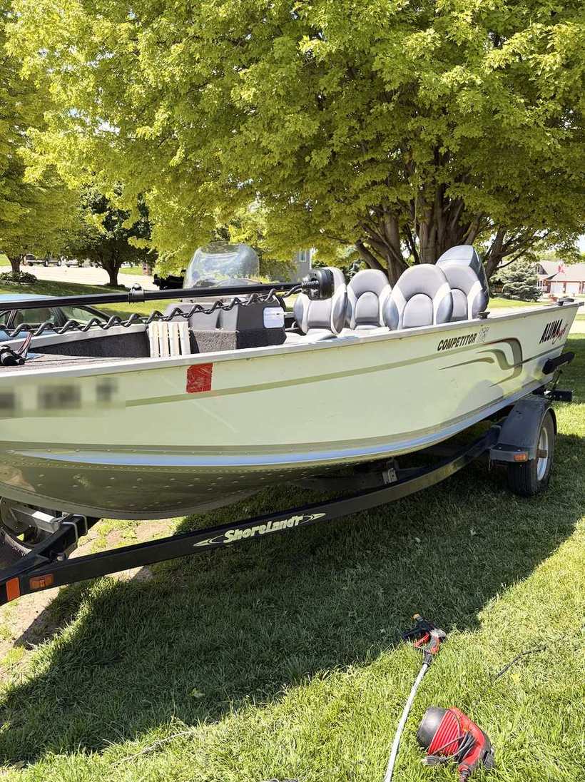 After — the same aluminum boat hull washed clean on its trailer